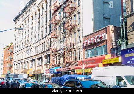 Stores and Shops Along a Busy Street in Chinatown, Manhattan. Multicolored Neighborhood with Chinese Style and Culture. New York City, USA Stock Photo