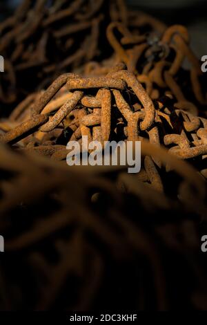 A Pile Of Old, Iron Rusty Chains Illuminated By The Sun. Stock Photo