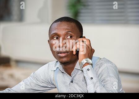 young man sitting in shirt communicating with the camera. Stock Photo