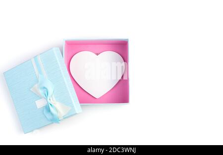 Blue gift box with a white big heart inside on a white background. Stock Photo