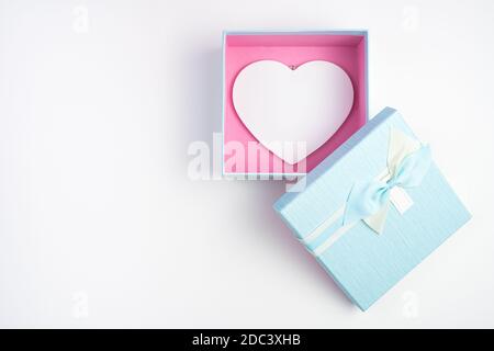 Gift box with a heart inside on a light background. Stock Photo