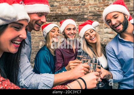 Merry Christmas and Happy New Year! Young freinds are celebrating holidays in  hause -  Group of young entrepreneurs are drinking champagne in coworki Stock Photo