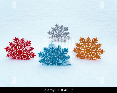 Christmas tree toys colored snowflakes on white snow. Stock Photo