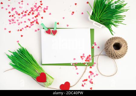 Romantic background with envelopes, a bouquet of wheat grass and hearts on a light background. Stock Photo