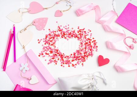 Hearts, envelopes, and ribbons on a light background. Romantic background, top View. Stock Photo