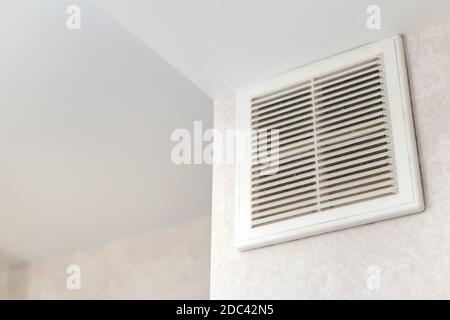 Dirty ventilation grille in the kitchen on the wall. Communication in the kitchen. Stock Photo