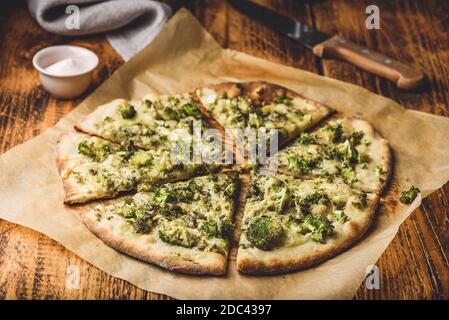 Homemade pizza with broccoli, pesto sauce and cheese Stock Photo
