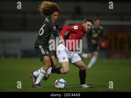 Manchester United's Hannibal Mejbri (left) and Morecambe's Ryan Cooney battle for the ball during the Papa John's Trophy match at the Globe Arena, Morecambe. Stock Photo