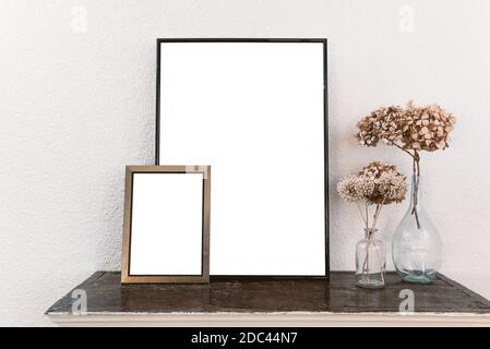 Empty picture frames on wooden shelf. Frame mockup. Stock Photo