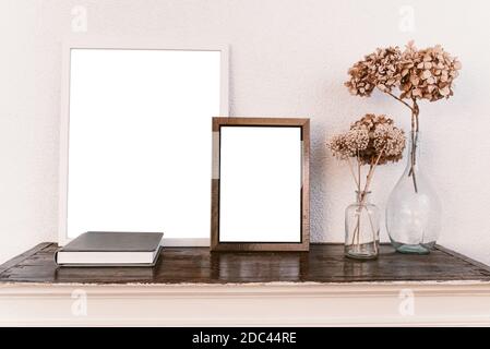 Empty picture frames on wooden shelf. Frame mockup. Stock Photo