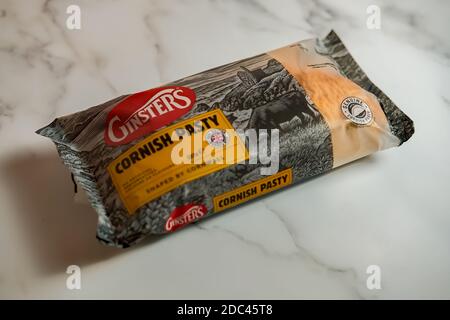 Norwich, Norfolk, UK – November 17 2020. An illustrative photo of a Ginsters readymade traditional Cornish pasty on a marbled white surface Stock Photo