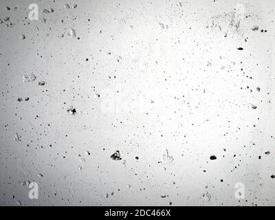 Concrete wall with irregularities painted with gray paint. Abstract gradient building surface background. Stock Photo