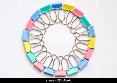 Colored iron paper clips. paper clips with many unique pastel color variants isolated on a white background, Binder clip is a simple device for bindin Stock Photo