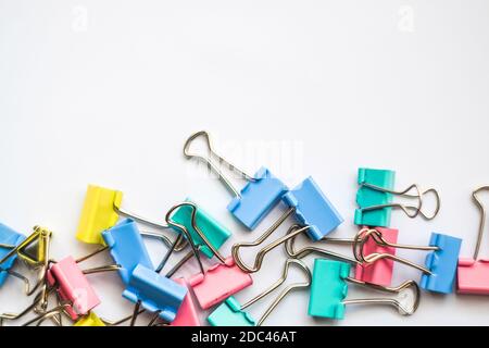 Colored iron paper clips. paper clips with many unique pastel color variants isolated on a white background, Binder clip is a simple device for bindin Stock Photo