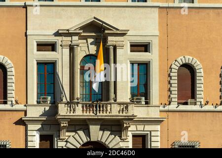 Via della Conciliazione, the General Secretariat of the Synod of Bishops with the flag of the Vatican City. Stock Photo