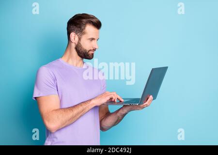 Photo portrait of young entrepreneur serious working on laptop doing project isolated bright blue color background Stock Photo