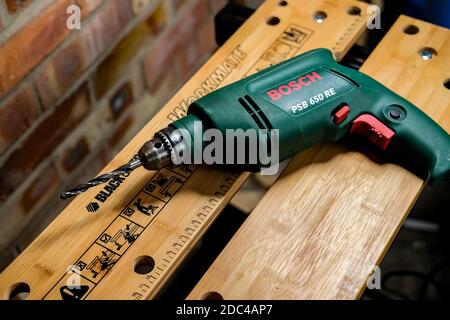 Norwich, Norfolk, UK – November 17 2020. An illustrative photo of a Bosch power drill on a Black & Decker Workmate bench Stock Photo
