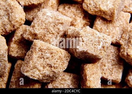 Heap brown cane unrefined sugar cubes Stock Photo