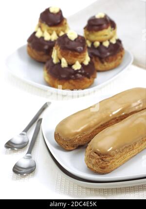 FRENCH CAKES CALLED CHOCOLATE RELIGIEUSE AND COFFE ECLAIR Stock Photo