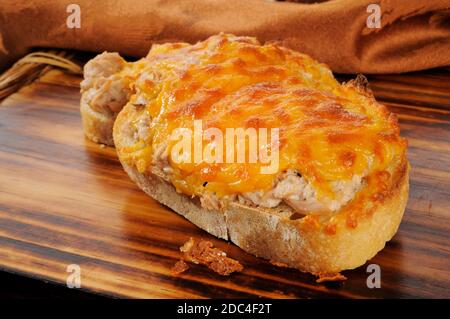 Closeup of a tuna melt topped with cheddar cheese Stock Photo