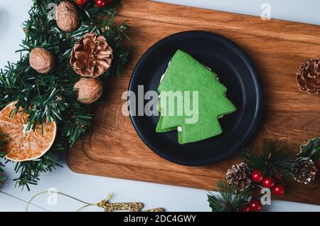 Christmas composition. Festive cookies in Christmas tree shape on wooden background. Stock Photo