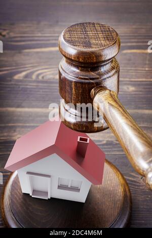 Gavel under small house Stock Photo