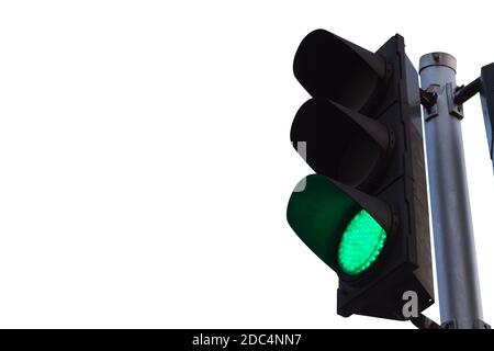 green color on the traffic light isolated on white background. Stock Photo