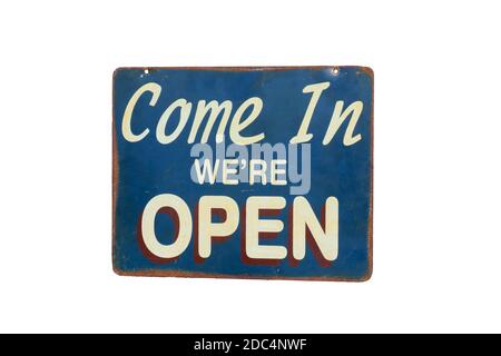 old rusty metal plate with word Come In We're Open isolated on white background Stock Photo