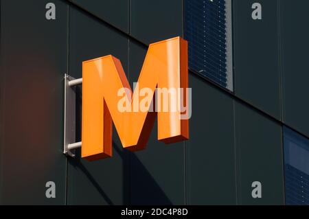 Lugano, Switzerland - 11th November 2020 : Migros supermarket store logo hanging in front of a shop in Lugano. Migros company is the biggest retail an Stock Photo