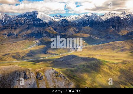 Aerial view of the snowcapped Brooks Range and tundra in the Arctic National Wildlife Refuge in Northeastern Alaska. The remote Arctic National Wildlife Refuge covers approximately 19.64 million acres of land and is the largest wilderness in the United States. Stock Photo