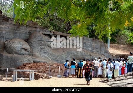 The Gal Vihara includes a reclining, a standing and two seated Buddha statues carved out of a single slab of granite rock at Polonnaruwa, Sri Lanka. Stock Photo