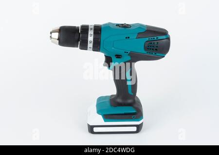 Green cordless hammer screwdriver drill on white background. The drill can be used as a drill hammer or a screwdriver or flat drill The drill has two Stock Photo
