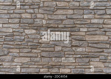 Horizontal decorative stone veneer applied on a wall Stock Photo