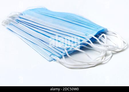 Blue three ply surgical mask on white Stock Photo