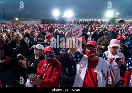Supporters look on as US President Donald Trump greets supporters as he hosts a Make America Great Again campaign event at Des Moines International Airport on October 14, 2020 in Des Moines, Iowa. Trump campaigns a week after recovering from COVID-19. Credit: Alex Edelman/The Photo Access Stock Photo
