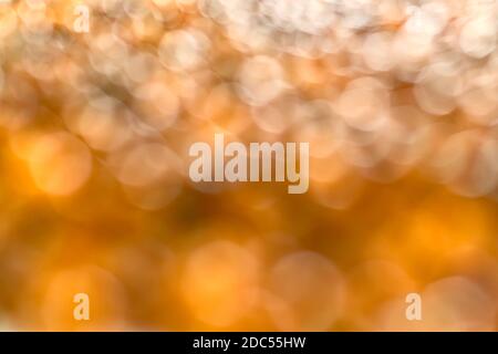 Sunny aerial blurred background. Many transparent bokeh circles on the side in yellow, grey and white. Stock Photo