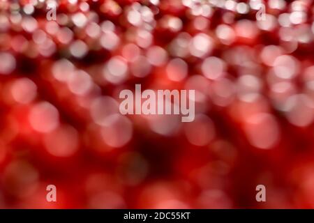 Background with bright red and white circles of different sizes, with dark blotches. From blur bokeh to sharpness. Stock Photo