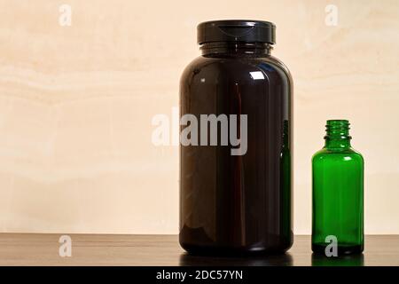 Black and green cosmetic bottles with shampoo and skincare cream. Herbal and natural cosmetics background with copy space for advertisement text Stock Photo
