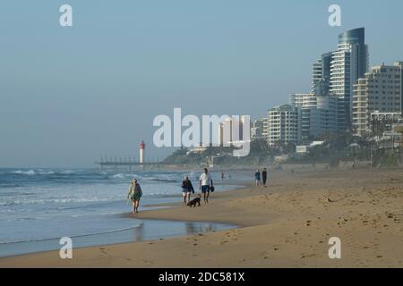 Landscape, people on holiday walking on beautiful beach, Umhlanga Rocks waterfront, Durban, KwaZulu-Natal, South Africa, seaside, local tourist Stock Photo