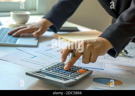 Male accountants are working on financial documents and calculators for business and finance expenses. Stock Photo