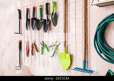 Different gardening supplies hanging on wall Stock Photo