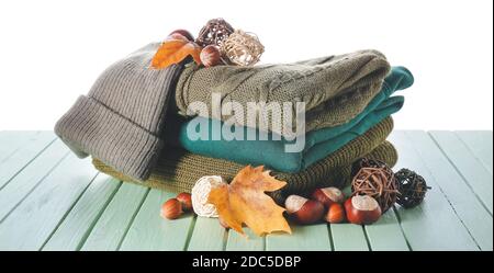 Stylish autumn clothes on table against white background Stock Photo