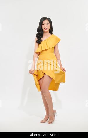 beautiful asian women swirling with happiness, in pretty yellow dress Stock Photo