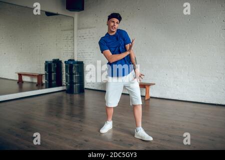 Energetic man making dance movements in the class Stock Photo