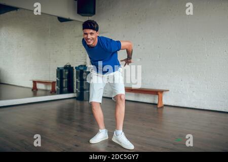 Man holding his hands behind the back while dancing Stock Photo