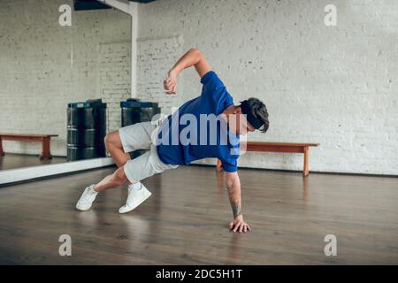 Man performing dance movements on the floor Stock Photo