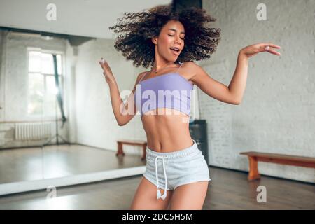 Woman doing active and bright dance routine Stock Photo