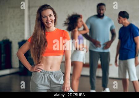 Smiling woman having a dance rehearsal with her colleagues Stock Photo