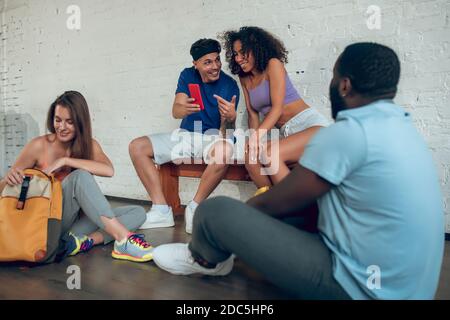 Dancers watching video on the smartphone and discussing it Stock Photo