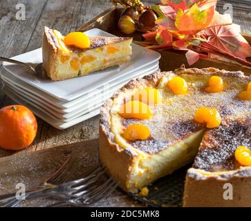 german cake with sour cream, custard orange filling on wooden table Stock Photo